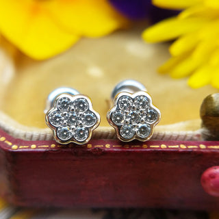 close up of our women's white gold flower stud earrings