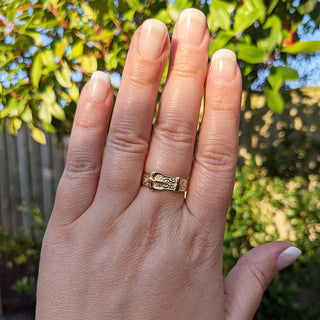 gold buckle ring on hand