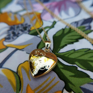 side view of pretty little gold heart locket necklace