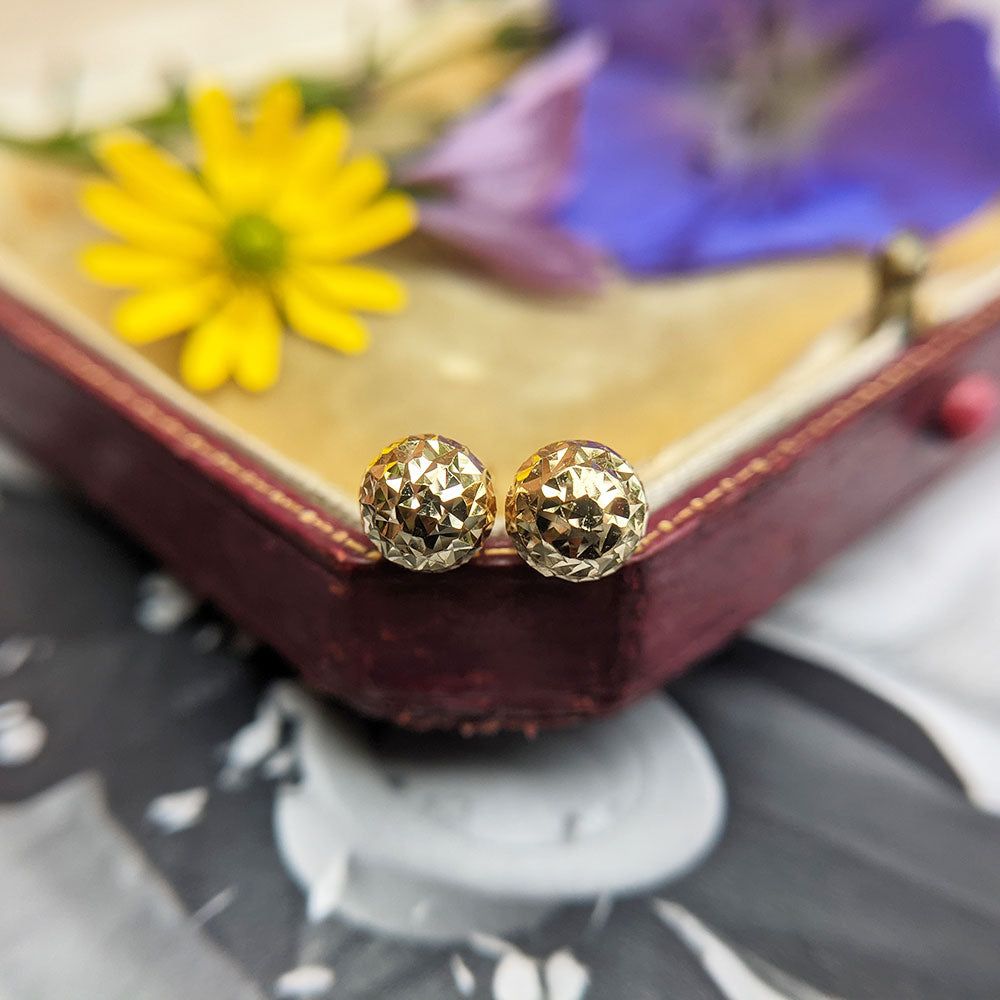 yellow gold ball stud earrings with a diamond cut