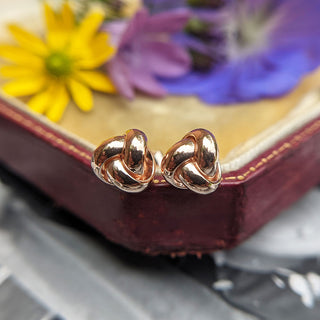 close up of rose gold celtic knot stud earrings