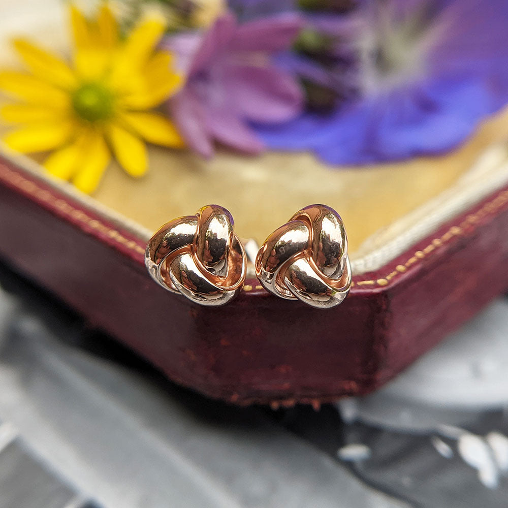 close up of rose gold celtic knot stud earrings