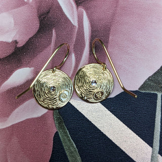 underside of disc drop earrings in yellow gold