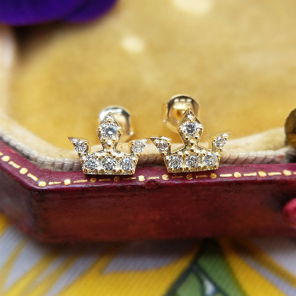close up of gold crown stud earrings