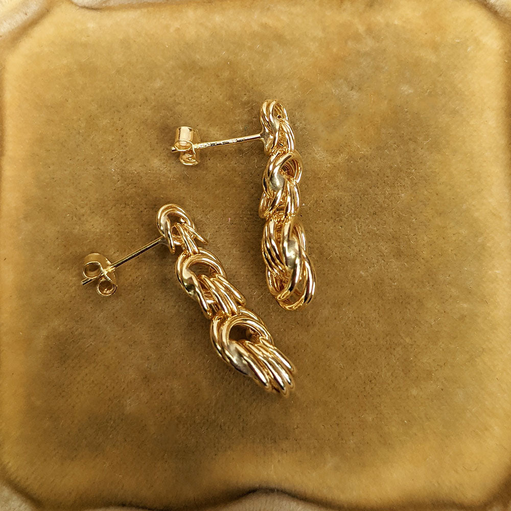 side view of post and butterfly fitting on gold drop earrings