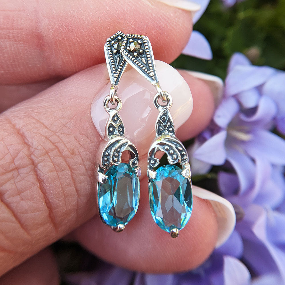 close up of vintage style blue paste earrings