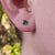 dainty emerald green studs in ear