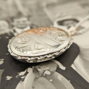 side profile of large ladies silver locket and chain