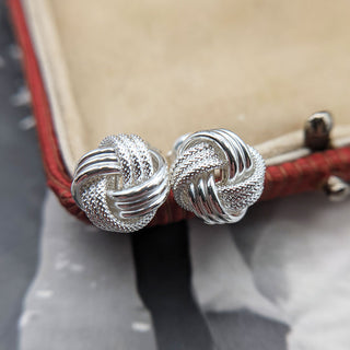 close up of sterling silver knot stud earrings