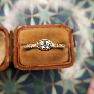 close up of yellow gold oval aquamarine ring