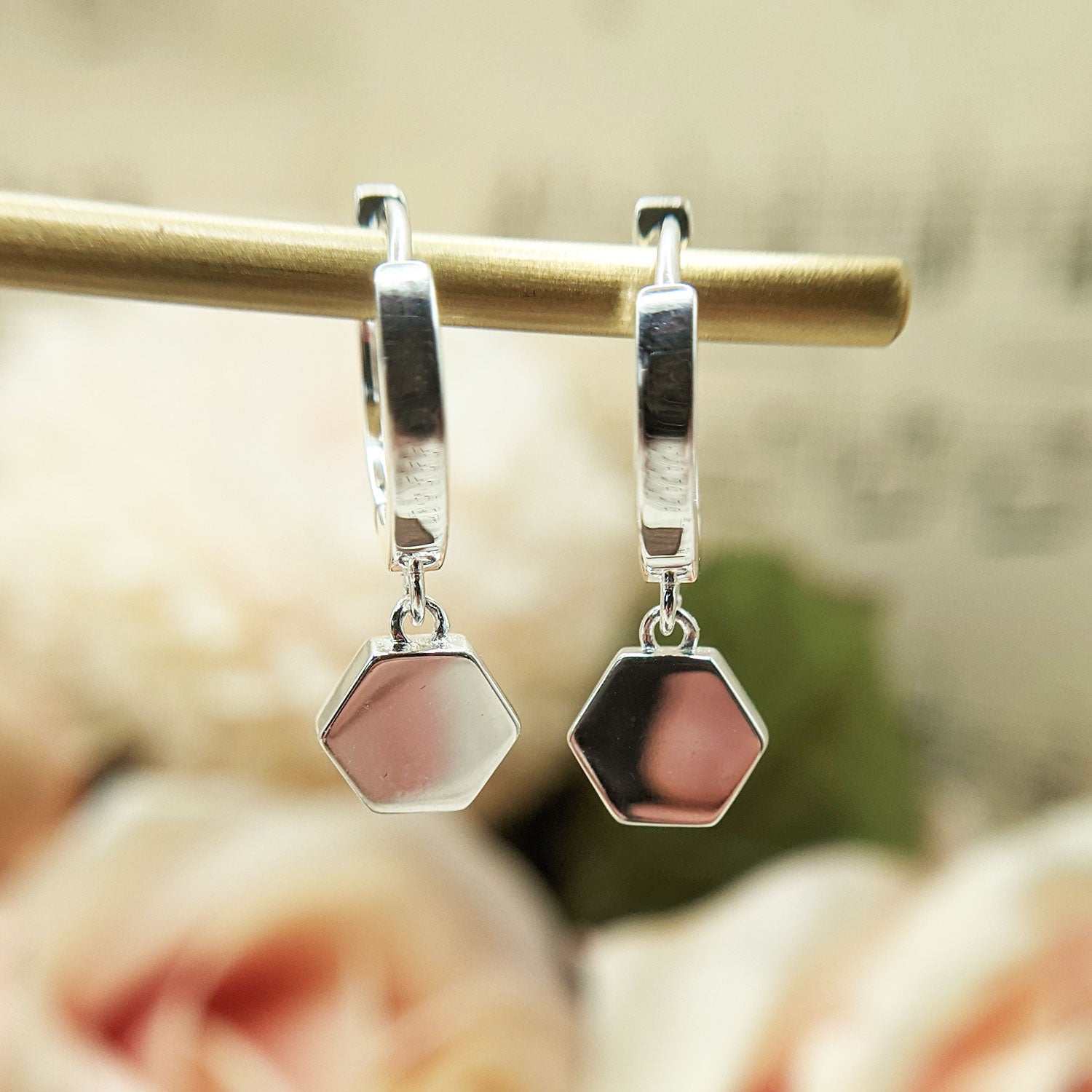 sterling silver huggie earrings with hexagon charm
